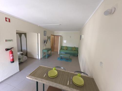 a living room with a table and a couch at Cozy apartment in Praia da Rocha in Portimão