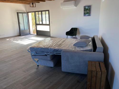 a bedroom with a bed and a chair in it at Grande maison de vacances in Perpignan