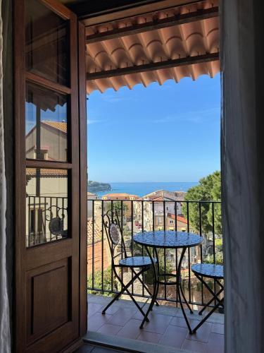 un patio con tavolo e sedie su un balcone di B&B Rivellini a Tropea