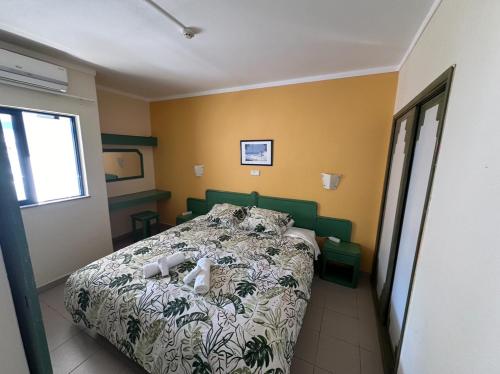 a bedroom with a bed with two stuffed animals on it at Cozy apartment in Praia da Rocha in Portimão