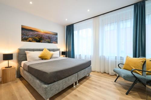 a bedroom with a bed and a large window at Deluxe Apartments Friedrichstrasse in Freiburg im Breisgau