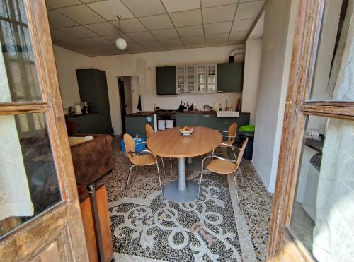 a kitchen and dining room with a table and chairs at Casa Valduggia in Valduggia