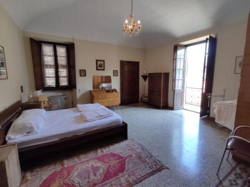 a bedroom with a bed and a chandelier at Casa Valduggia in Valduggia