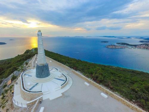 an aerial view of a lighthouse next to the water at Apartman Pida in Primošten