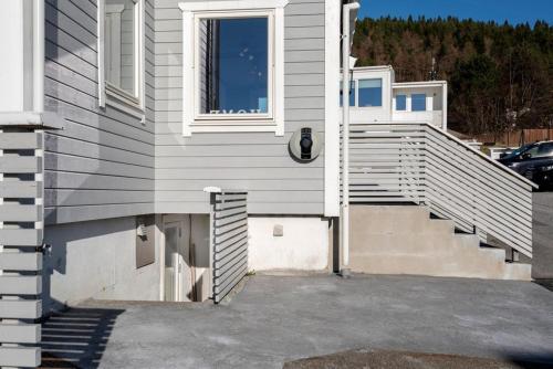 a house with stairs and a window on it at Apartment close to Aalesund center in Ålesund