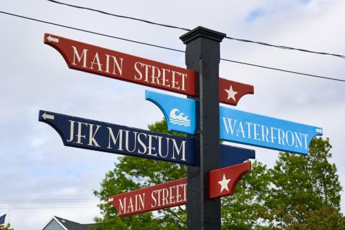 a pole with several street signs on it at Heritage House Inn in Hyannis