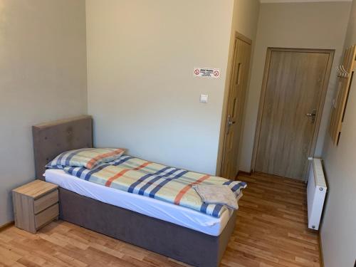 a small bedroom with a bed in a room at Zajazd Jagoda Pokoje i Restauracja 