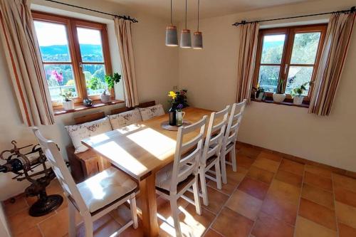 a dining room with a wooden table and chairs at Naturjuwel inmitten der Weinberge in Sankt Stefan ob Stainz