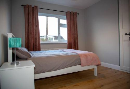 a bedroom with a bed and a window at Forkfield Country House in Westport