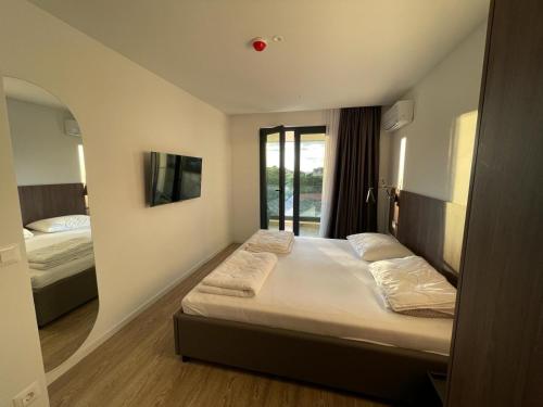 a hotel room with two beds and a window at Uzelac apartment with pool in Makarska