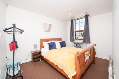 a bedroom with a bed and a window at 3 bed apartment, centre of Rochdale in Rochdale