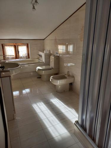 a bathroom with two toilets and a sink at Casa Giuly in Quartu SantʼElena