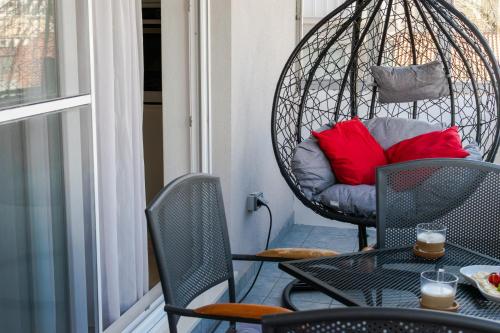 a porch with a chair and a table with red pillows at Beachfront apartment Plaza in Omiš