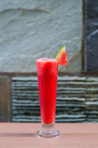 a red drink with a piece of watermelon in it at Hotel Ocean Grand at Hulhumale in Hulhumale