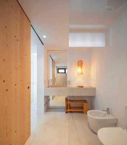 a bathroom with a sink and a toilet and a mirror at Comporta.threeHouse in Brejos, Portugal in Comporta
