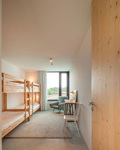 a bedroom with two bunk beds and a desk at Comporta.threeHouse in Brejos, Portugal in Comporta