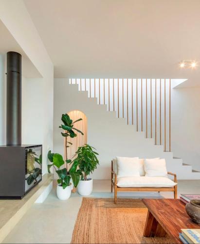 a living room with a white couch and stairs at Comporta.threeHouse in Brejos, Portugal in Comporta