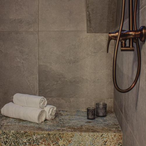 a bathroom with towels on a counter and a shower at Apartament Sarenka in Rogożnik