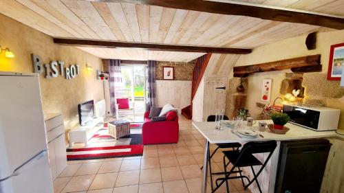 Il comprend une cuisine et un salon avec un canapé rouge. dans l'établissement Les Gîtes du Kokopelli : Havana, à Plumelec