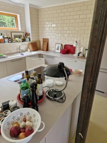 a kitchen counter with a bowl of fruit on it at Naturnahes Wohnen in einem alten Haus mit Garten in Windeck