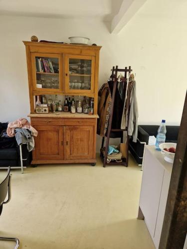 a room with a wooden cabinet in a room at Naturnahes Wohnen in einem alten Haus mit Garten in Windeck