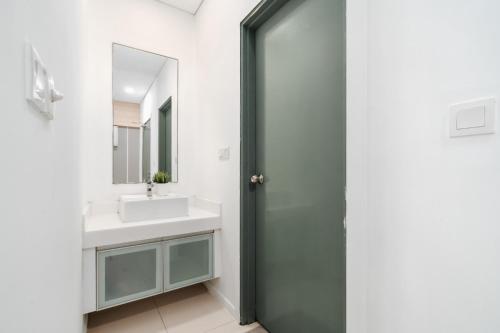 a bathroom with a sink and a mirror at Summer Suite KLCC in Kuala Lumpur