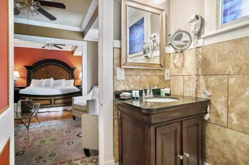 a bathroom with a sink and a bedroom with a bed at Casablanca Inn on the Bay in St. Augustine