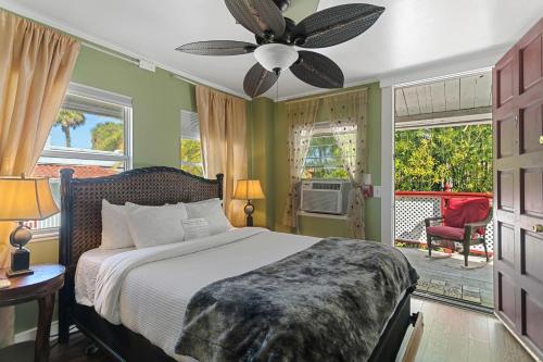 a bedroom with a bed and a ceiling fan at Casablanca Inn on the Bay in St. Augustine