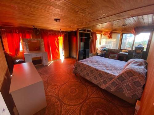 a bedroom with a bed and a living room at Amplia Casa a 4 cuadras de playa in Los Vilos