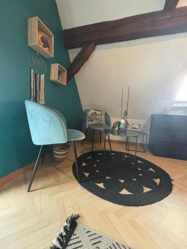 a living room with two chairs and a table at Charmant Appartement proche Strasbourg à Eckwersheim in Eckwersheim