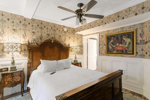a bedroom with a bed and a ceiling fan at Casablanca Inn on the Bay in Saint Augustine