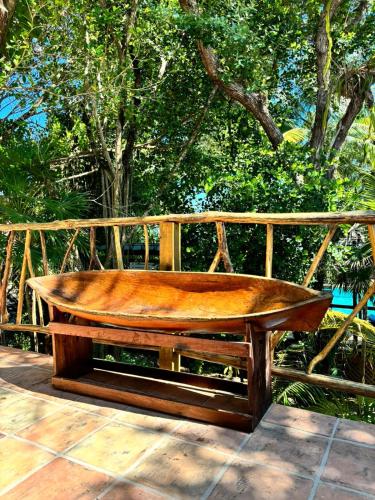 a wooden bench sitting on top of a deck at Azure Del Mar in Maya Beach