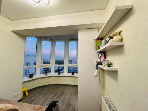 an empty room with a hallway with windows at Apartament lux Chisinau in Chişinău