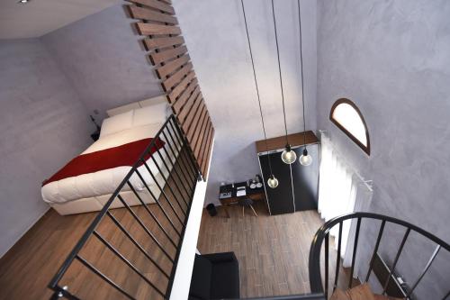 a room with a bed and a spiral staircase at Quaint Boutique Hotel Nadur in Nadur