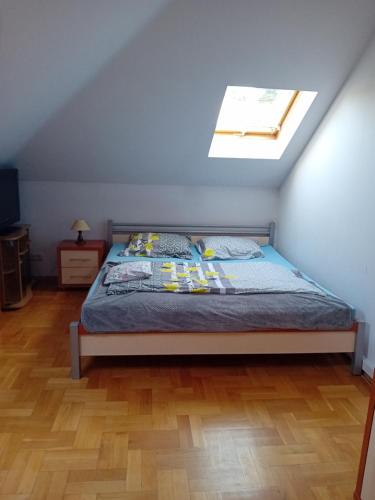 a bedroom with a bed and a skylight at Orkana44F in Mszana Dolna