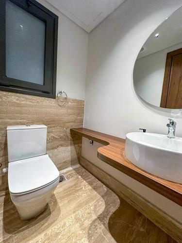 a bathroom with a white toilet and a sink at 89B-106 at Lake View Residence in New cairo