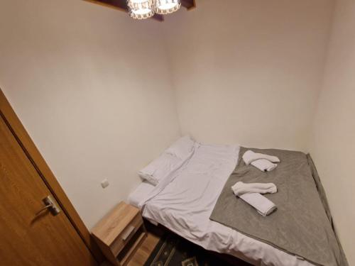 a small bedroom with a bed with towels on it at Dursi Home in Drajna de Sus