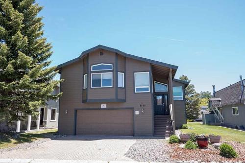 a brown house with a garage in a yard at 1759 Venice Drive home in Tahoe Keys