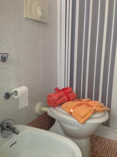 y baño con aseo y toallas. en Beach mini appartamento, en Margherita di Savoia