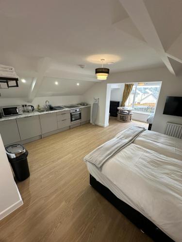 a large bedroom with a bed and a kitchen at The Highmead in Blackwood