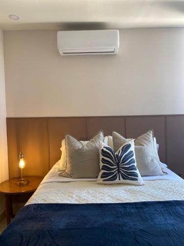 a bedroom with a bed with pillows on it at Departamento Arena Vive in Monterrey