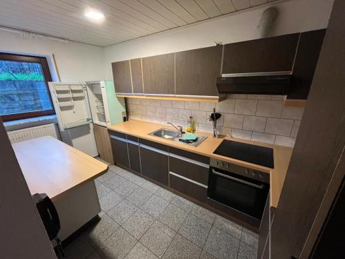 a kitchen with a sink and a counter top at Ferienzimmer in Bad Mergentheim-Wachbach in Bad Mergentheim