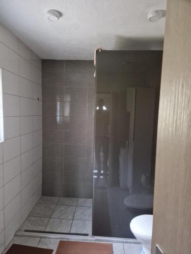 a shower stall in a bathroom with a toilet at Mountain Home Paravci in Čajniče