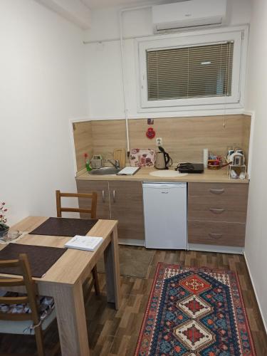 a kitchen with a table and a sink and a counter at MBM Apartments 1 in Sarajevo