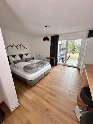 a bedroom with a bed and a wooden floor at Grimming Lodge Tauplitz in Tauplitz