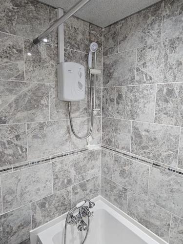 a bathroom with a shower and a bath tub at Airbnb Palace in Birmingham
