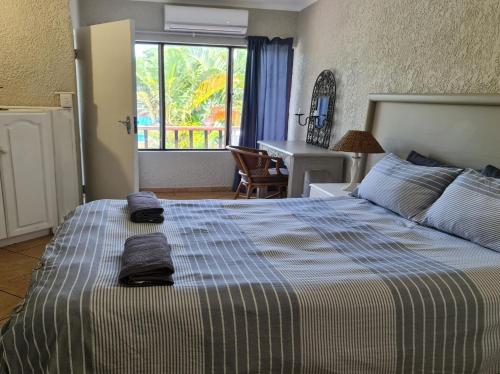 a bedroom with a bed with towels on it at Villa Mia 9, St Lucia in Popular tourist town near beaches in St Lucia