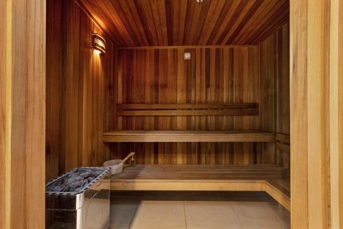 a sauna with a bench in a wooden room at Birch Apartments by the Lake in Canberra