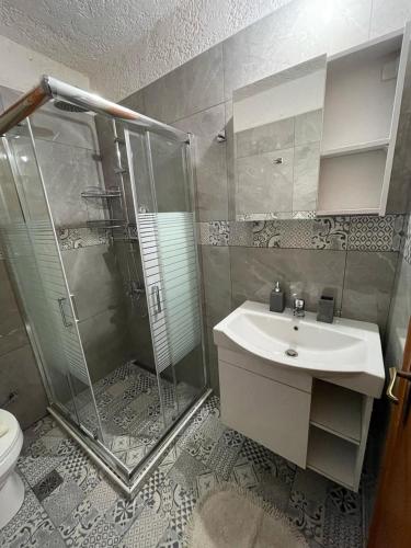 a bathroom with a sink and a shower at Sophia's maisonette 2 in Stoupa