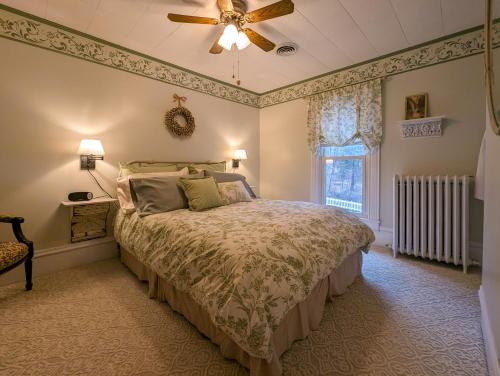 a bedroom with a bed and a ceiling fan at Hudson Manor Bed & Breakfast in Watkins Glen